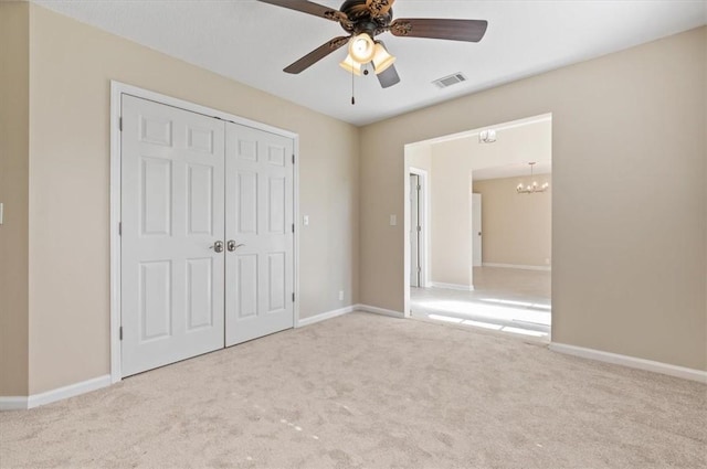 unfurnished bedroom with a closet, visible vents, carpet flooring, and baseboards