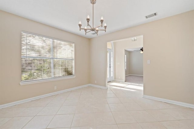 spare room with light tile patterned floors, visible vents, baseboards, and ceiling fan with notable chandelier