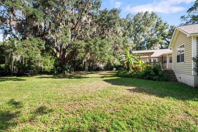 view of yard with a wooden deck