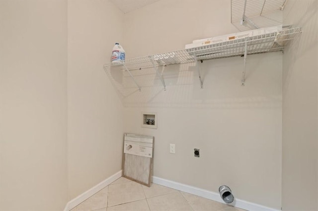 washroom featuring washer hookup, light tile patterned flooring, baseboards, hookup for an electric dryer, and laundry area