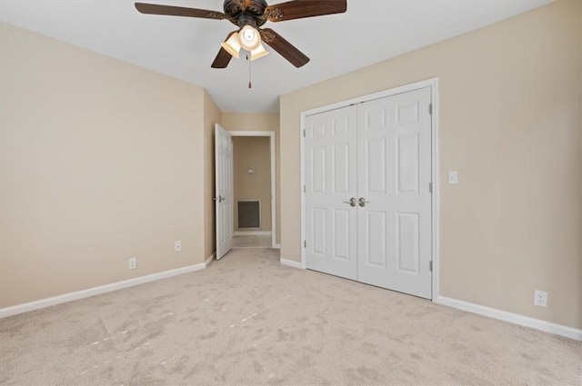 unfurnished bedroom with visible vents, a ceiling fan, a closet, carpet, and baseboards