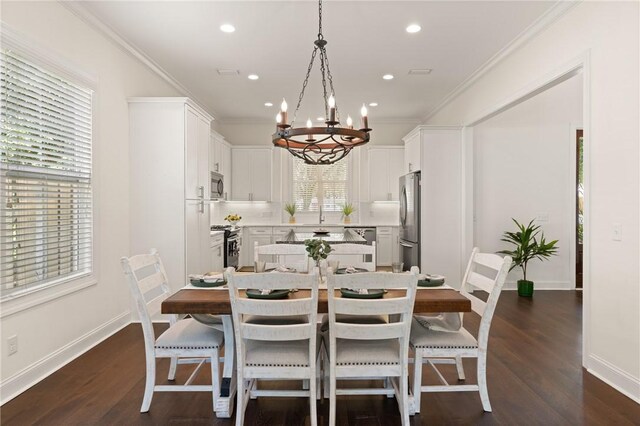 1040 Sinclair Pointe, Saint Simons Island, GA 31522 - kitchen with white cabinets, stainless steel microwave, an inviting chandelier, and dark wood finished floors