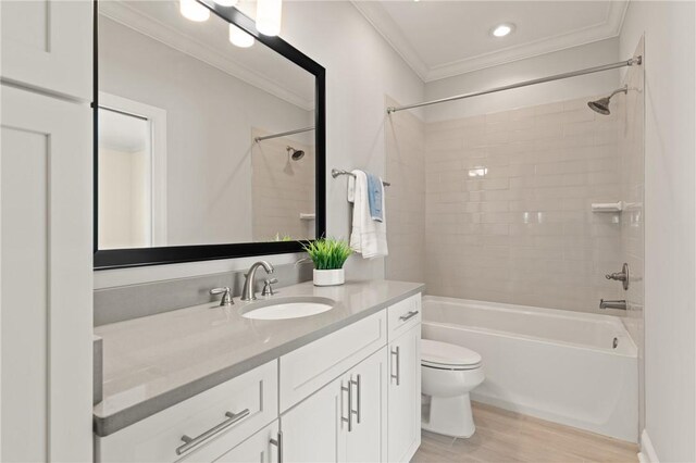 1040 Sinclair Pointe, Saint Simons Island, GA 31522 - full bath featuring tile patterned flooring, vanity, crown molding, toilet, and washtub / shower combination