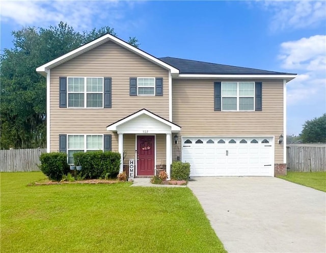 view of front of property with a garage and a front lawn