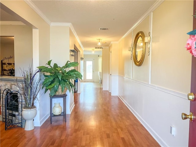 corridor featuring wood-type flooring and crown molding