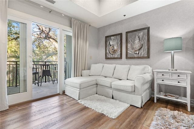 living room with baseboards and wood finished floors
