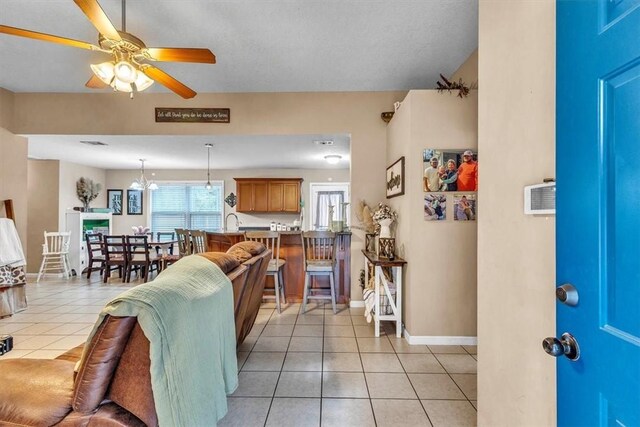 203 Hendrix St NE, Ludowici, GA 31316 - living area with baseboards, a ceiling fan, and light tile patterned floors