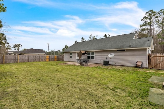 203 Hendrix St NE, Ludowici, GA 31316 - back of house with a fenced backyard, a lawn, central AC unit, and a patio