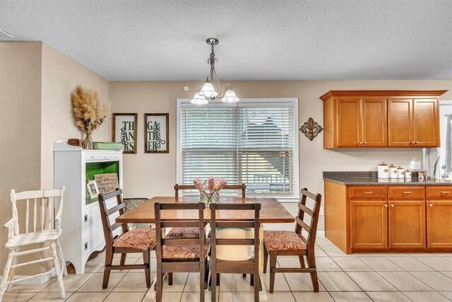 203 Hendrix St NE, Ludowici, GA 31316 - dining area featuring light tile patterned floors, a chandelier, and a textured ceiling