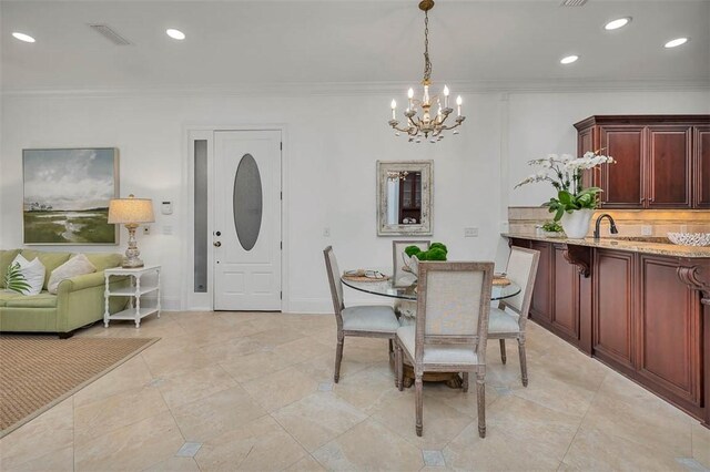 3100 Prince Ln, Saint Simons Island, GA 31522 - dining space featuring a chandelier, crown molding, recessed lighting, and baseboards