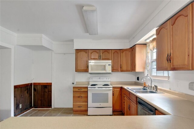 124 Ryals Rd, Brunswick, GA 31523 - kitchen featuring white appliances, light countertops, and brown cabinets