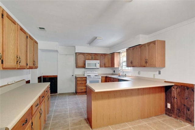 124 Ryals Rd, Brunswick, GA 31523 - kitchen featuring white appliances, a peninsula, and light countertops