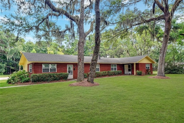 124 Ryals Rd, Brunswick, GA 31523 - ranch-style house with a front yard, brick siding, and view of scattered trees