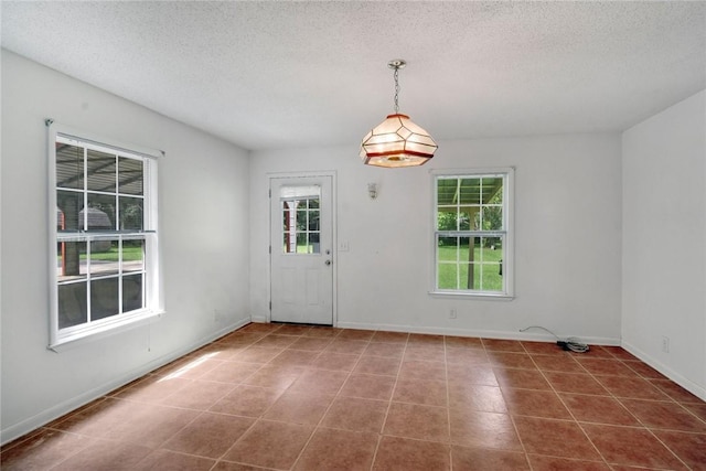 124 Ryals Rd, Brunswick, GA 31523 - unfurnished dining area featuring a textured ceiling