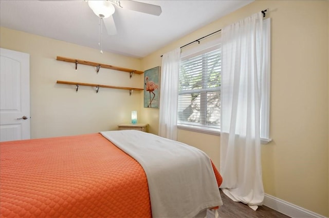 bedroom with baseboards and a ceiling fan