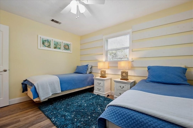 bedroom featuring wood finished floors, baseboards, and ceiling fan