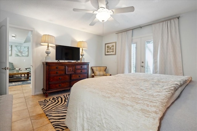 bedroom with light tile patterned flooring, access to exterior, and ceiling fan