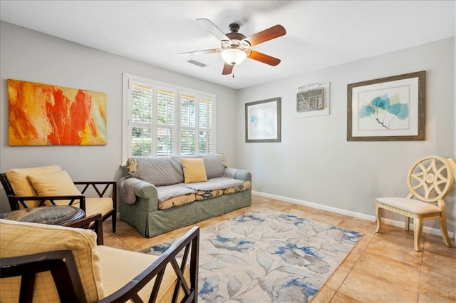 tiled living area with ceiling fan and baseboards