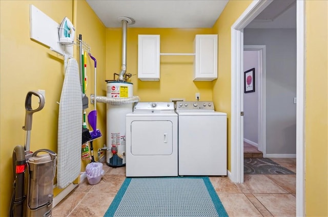 laundry room with water heater, independent washer and dryer, and cabinet space