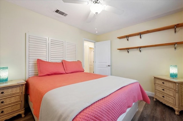 bedroom featuring dark wood finished floors, baseboards, and a ceiling fan