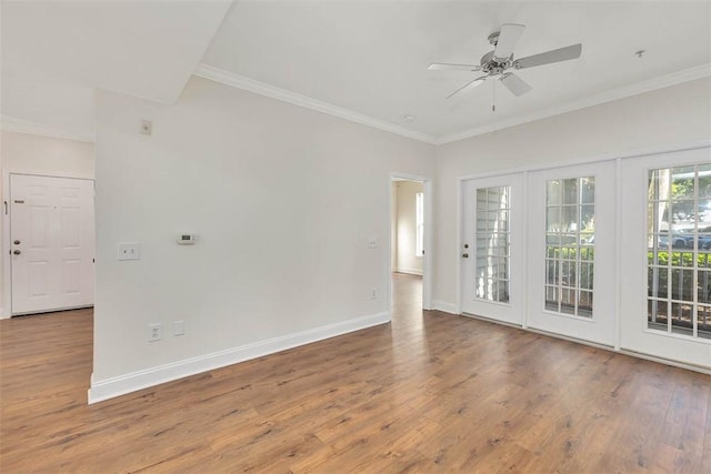 spare room featuring ceiling fan, crown molding, and wood finished floors