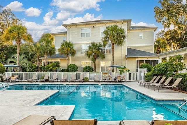 pool featuring a patio area and fence