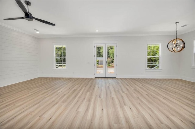 unfurnished room featuring french doors, light hardwood / wood-style flooring, ceiling fan with notable chandelier, and ornamental molding