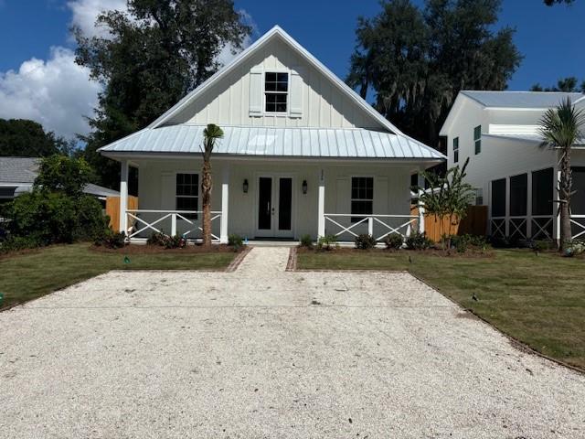 view of front facade featuring french doors and a front lawn