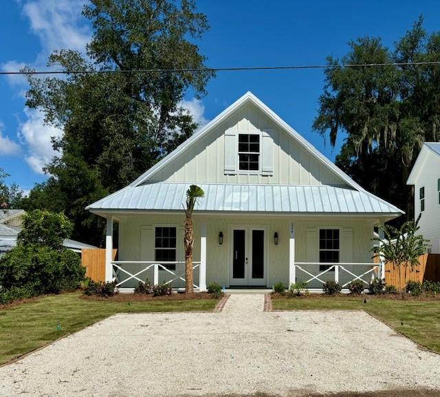 view of front of home with a front yard and french doors