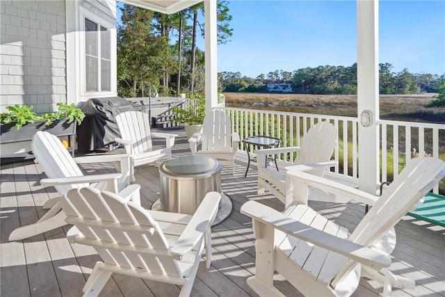 wooden deck featuring a grill