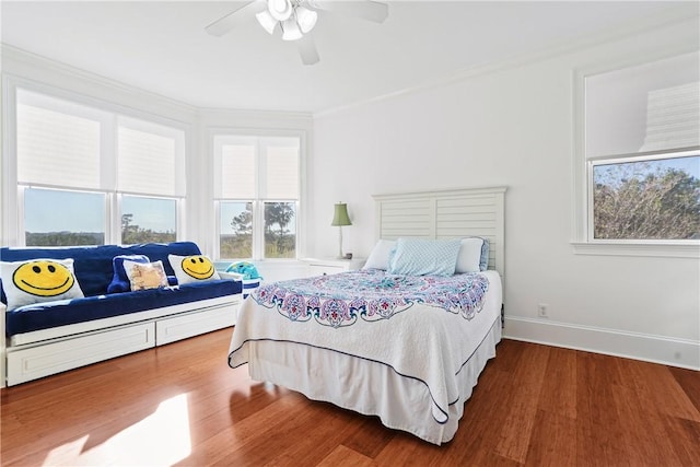 bedroom featuring hardwood / wood-style floors, ceiling fan, and ornamental molding