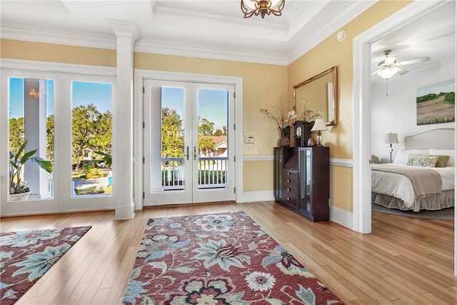 doorway to outside with ornamental molding, light hardwood / wood-style flooring, and french doors