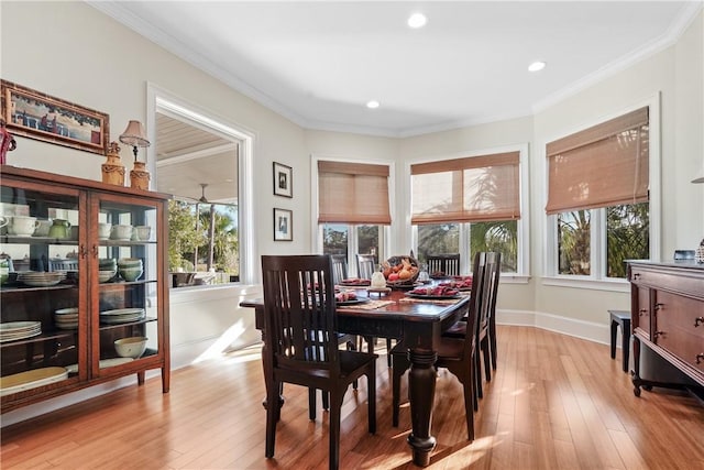 dining area with crown molding and light hardwood / wood-style flooring