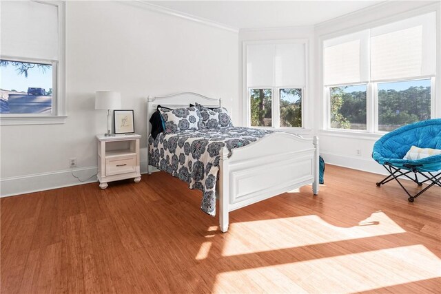 bedroom featuring hardwood / wood-style floors and ornamental molding