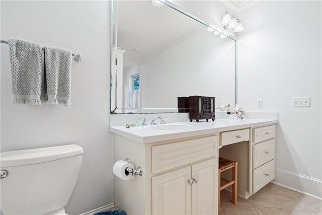 bathroom featuring tile patterned flooring, vanity, toilet, and crown molding