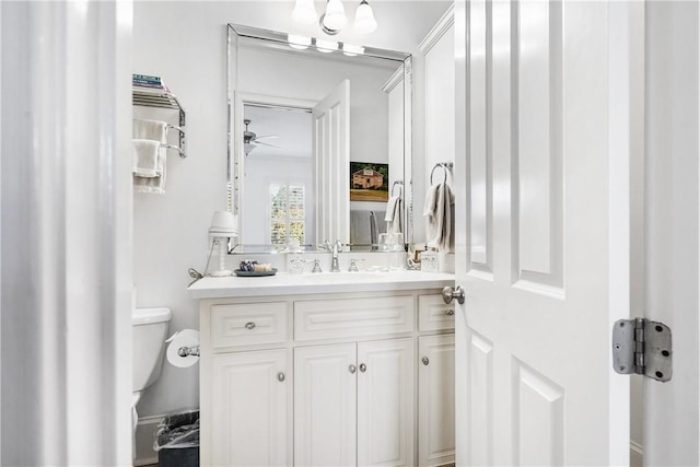 bathroom with ceiling fan, vanity, and toilet