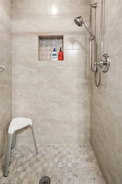 bathroom with tiled shower