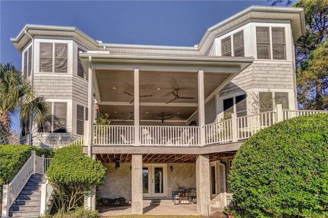 rear view of house featuring ceiling fan, a patio area, and french doors