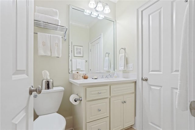 bathroom featuring crown molding, vanity, and toilet