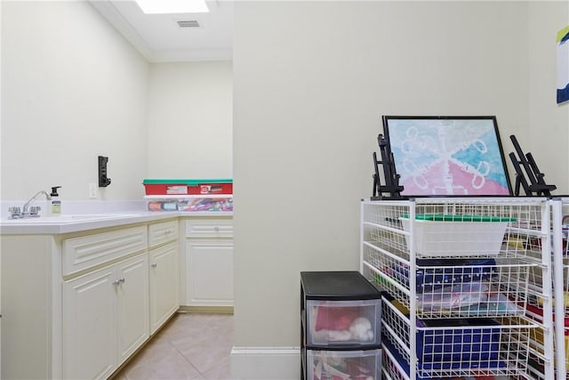 interior space with light tile patterned floors and sink