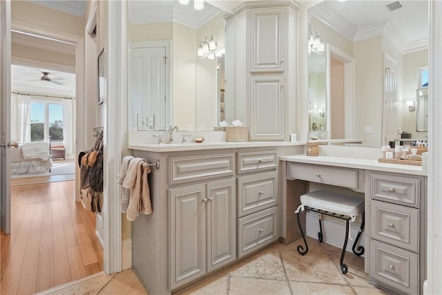 bathroom featuring crown molding, vanity, and hardwood / wood-style flooring