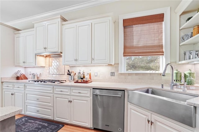 kitchen with backsplash, crown molding, sink, appliances with stainless steel finishes, and white cabinetry