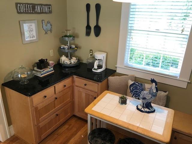 kitchen with tile countertops and wood finished floors