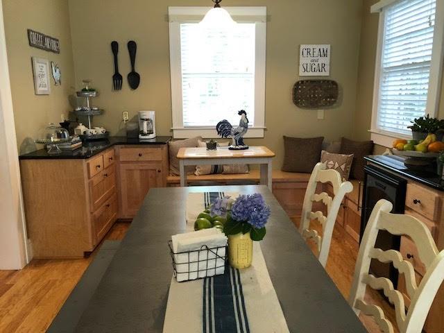 kitchen with dark countertops, light wood-style flooring, plenty of natural light, and decorative light fixtures