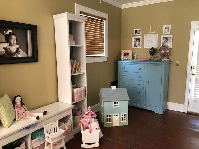 bedroom with crown molding and baseboards