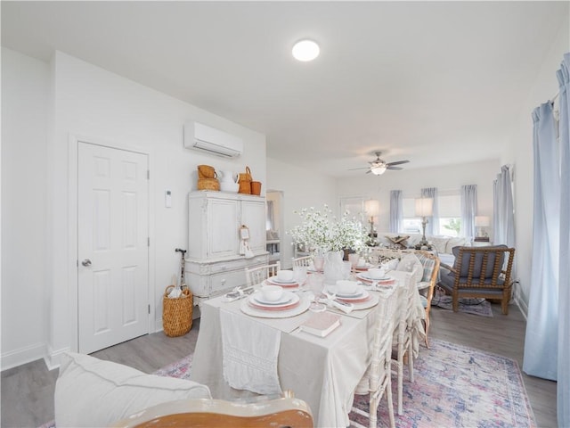 1007 Elbert Ext, Darien, GA 31305 - dining area featuring a wall mounted AC, light wood-style flooring, and a ceiling fan