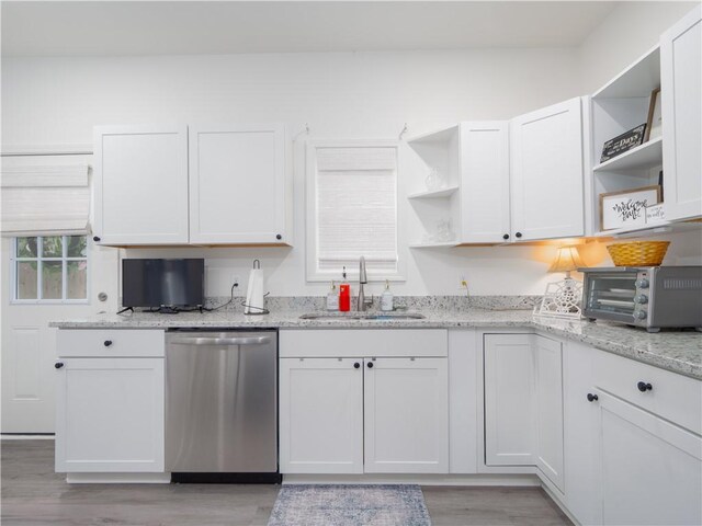 1007 Elbert Ext, Darien, GA 31305 - kitchen featuring dishwasher, open shelves, light wood-style floors, white cabinets, and light stone countertops