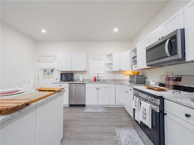 1007 Elbert Ext, Darien, GA 31305 - kitchen with appliances with stainless steel finishes, open shelves, white cabinetry, light wood-style flooring, and recessed lighting