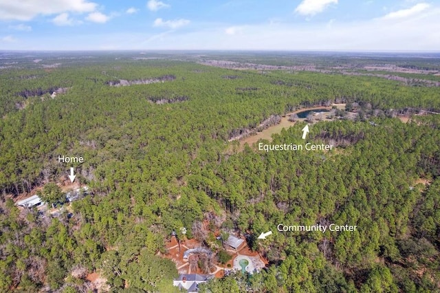 bird's eye view featuring a wooded view