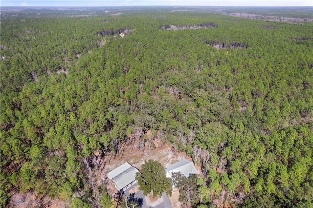 drone / aerial view featuring a view of trees